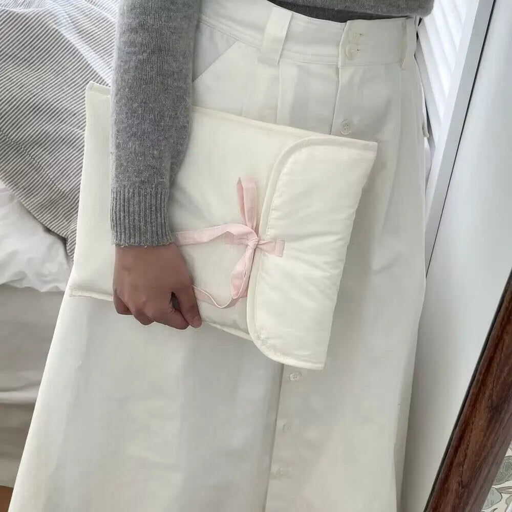 Women's black and white quilted nylon computer bag with ballet bow detailing and striped pattern