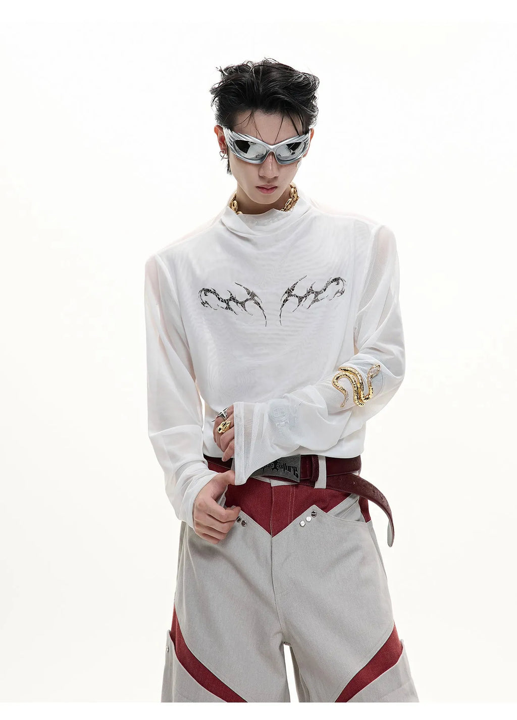 Man wearing a black slim fit long sleeve mesh base layer shirt.