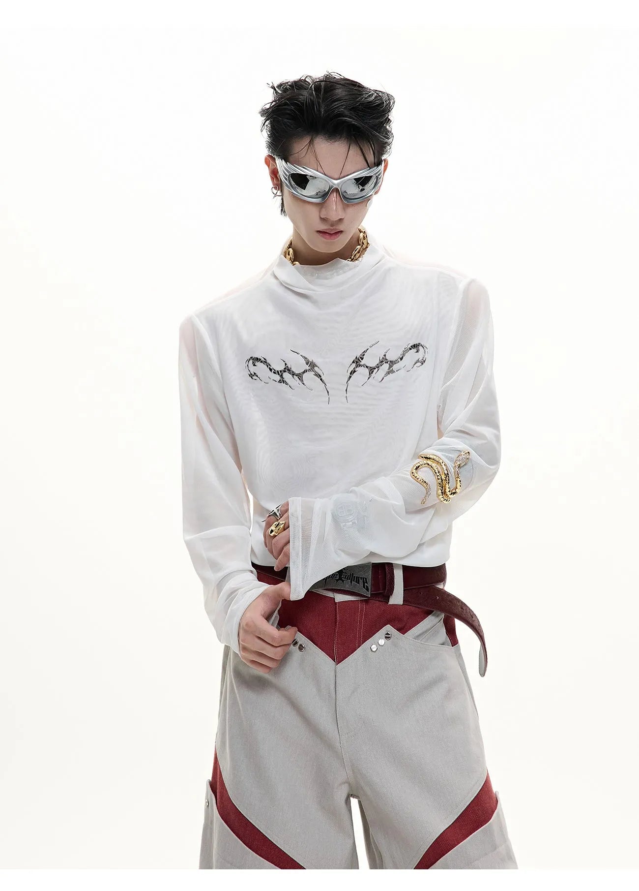 Man wearing a black slim fit long sleeve mesh base layer shirt.