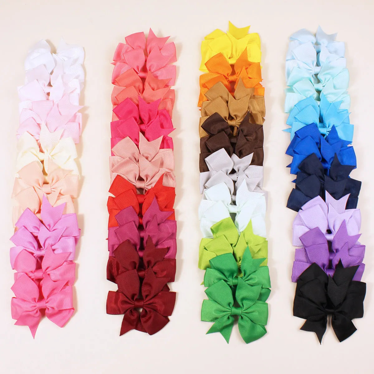 Assorted colours of 3-inch grosgrain ribbon pinwheel hair bows with alligator clips for toddlers.