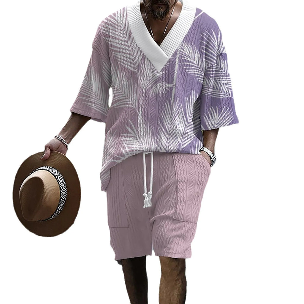 A man wearing a printed drop-shoulder knitted short-sleeved top with matching shorts in a casual setting.
