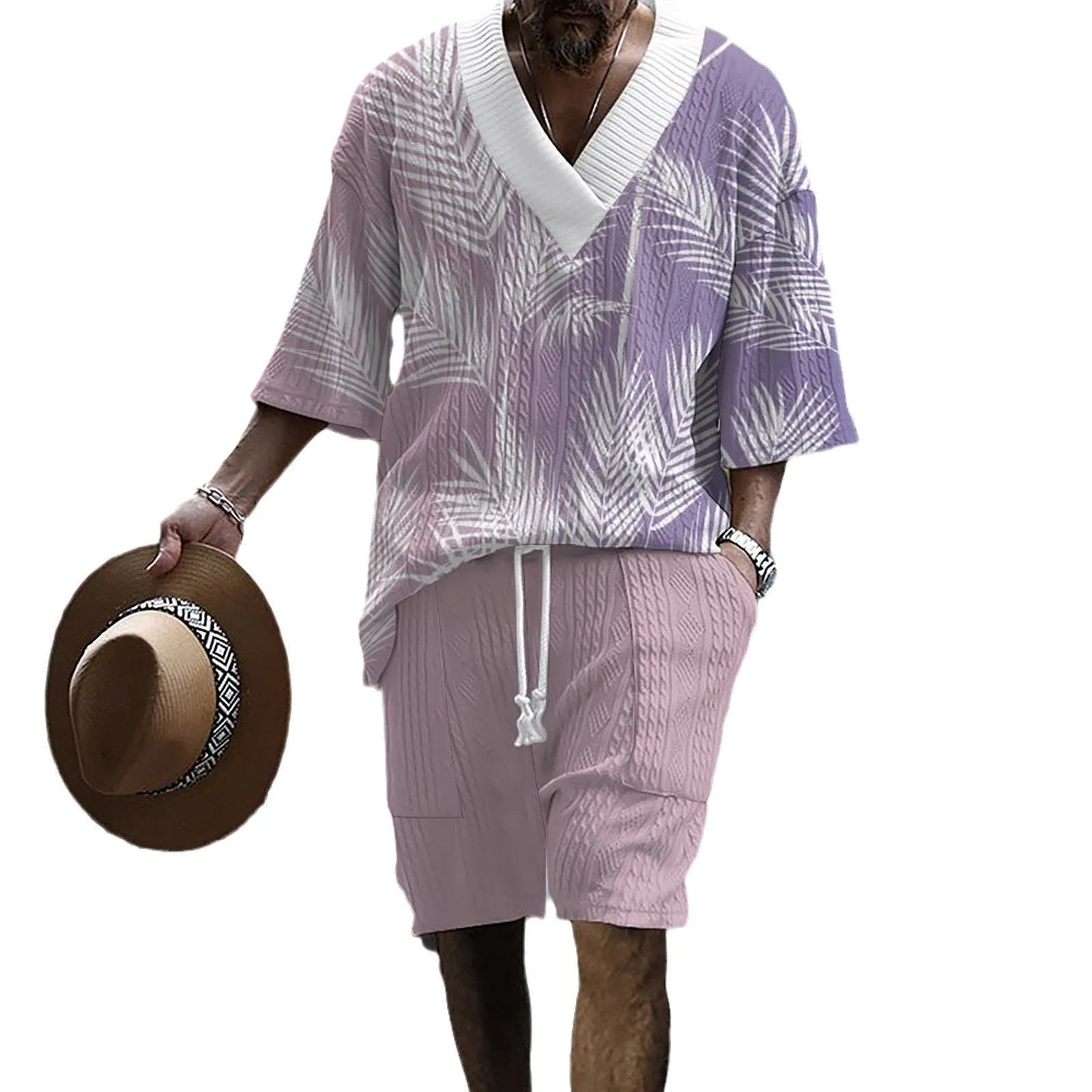A man wearing a printed drop-shoulder knitted short-sleeved top with matching shorts in a casual setting.