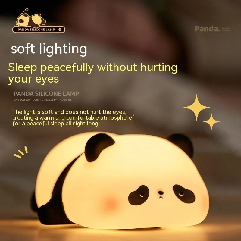 Panda shaped silicone night light with warm white glow on dark surface