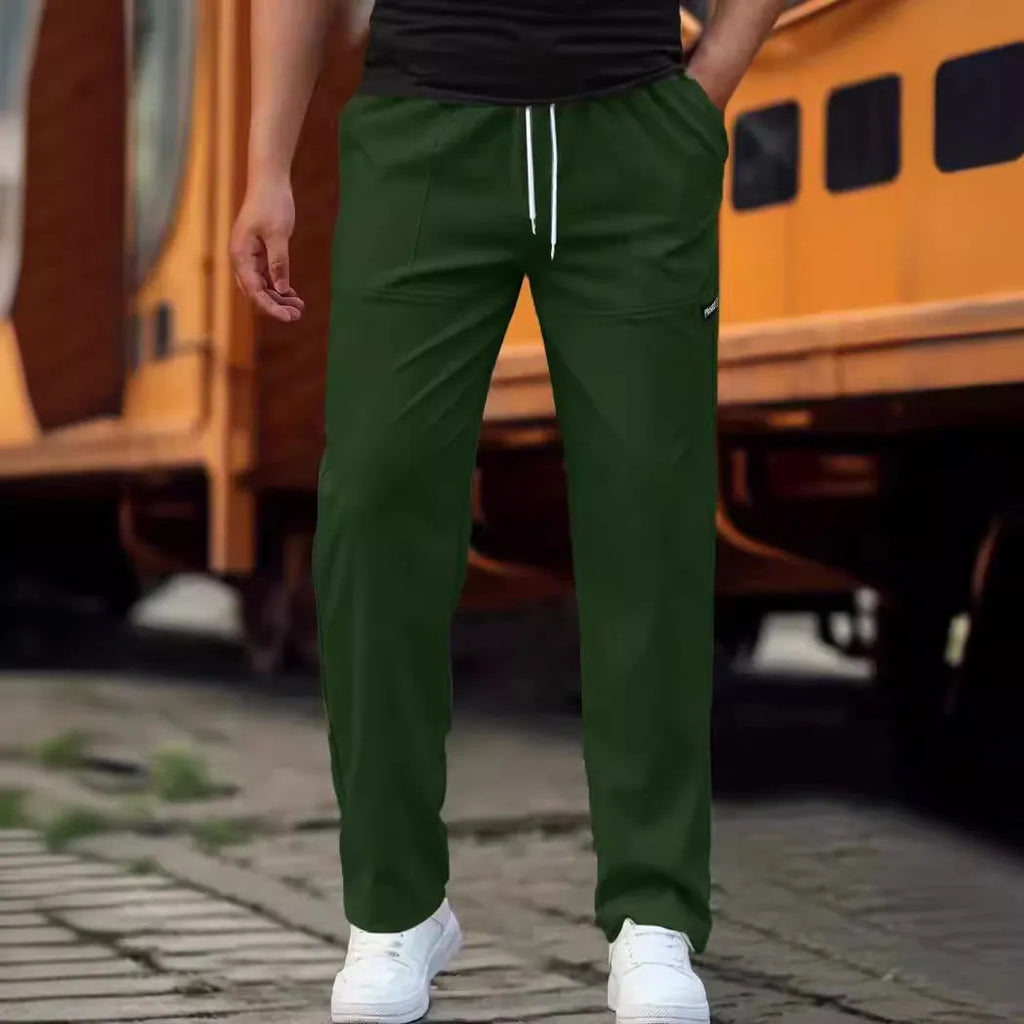 Men's polyester trousers for spring and autumn in light grey, shown flat.