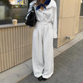 White striped wide-leg women's trousers with zipper, loose fit for commuting.