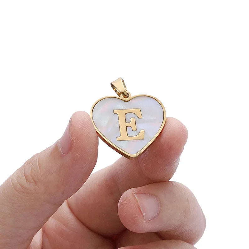 Gold heart necklace with white shell detail and personalised initial letter on adjustable chain