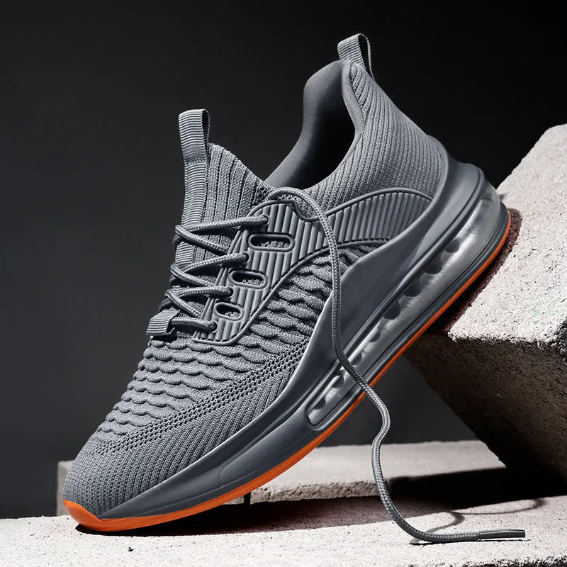 Men's black low-top running shoes with mesh upper and white rubber sole on a plain background.