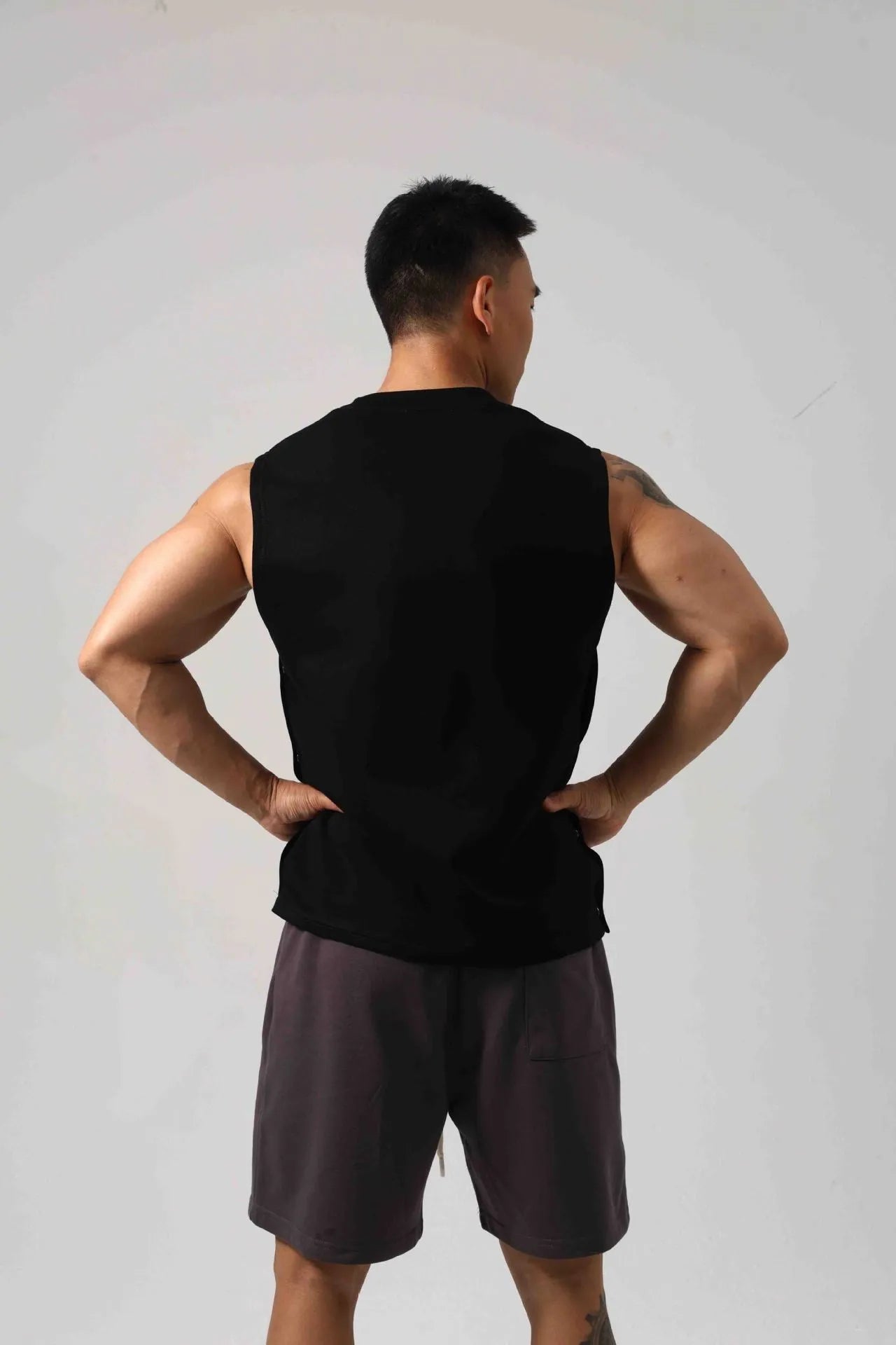 Korean style men's loose cotton fitness vest with hidden hook side openings in black, blue, grey, or white.