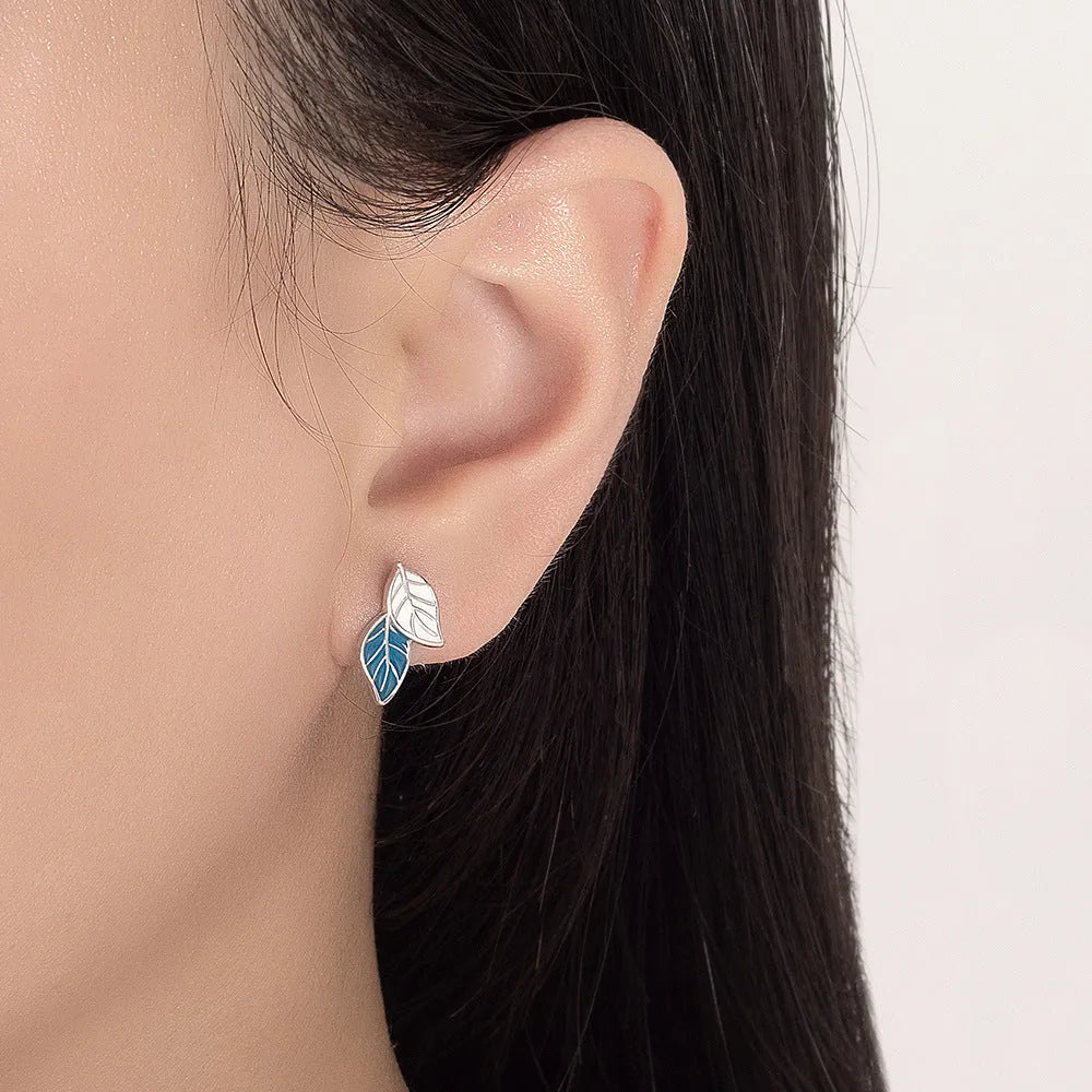 White gold plated copper leaf-shaped stud earrings for women on white background