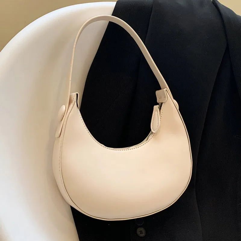 Women's cream yellow retro dumpling-shaped PU leather shoulder bag showing front and internal zippered pocket.