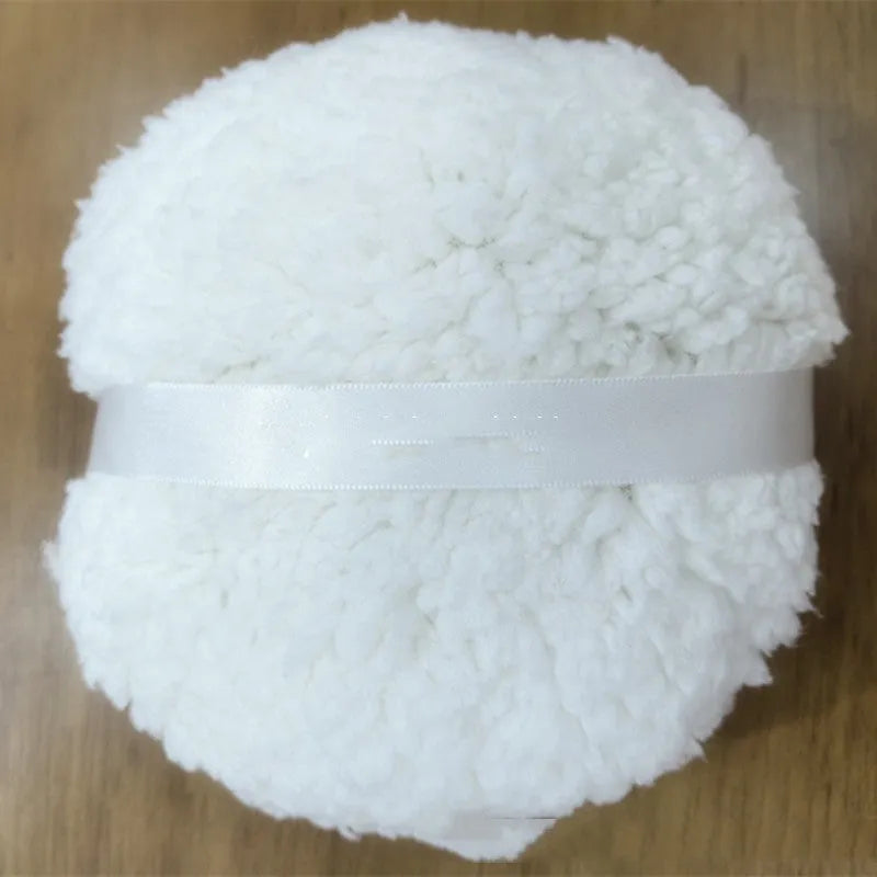 Oversized soft plush makeup powder puff in pink, white, and skin colour on a white background
