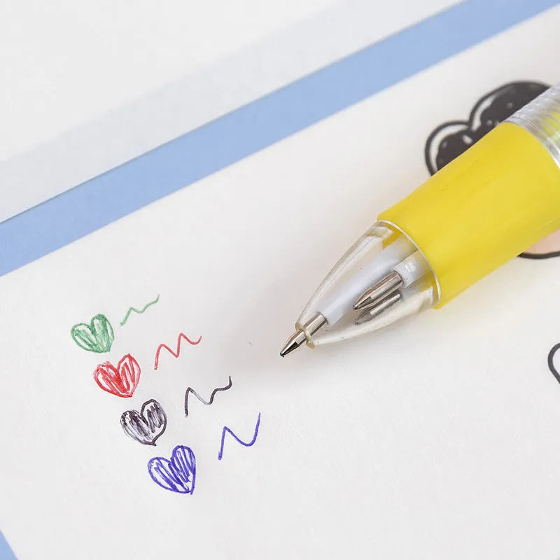 A cartoon-themed press-type ballpoint pen showing four-colour cartridge and a random print design on a silicone and plastic barrel.