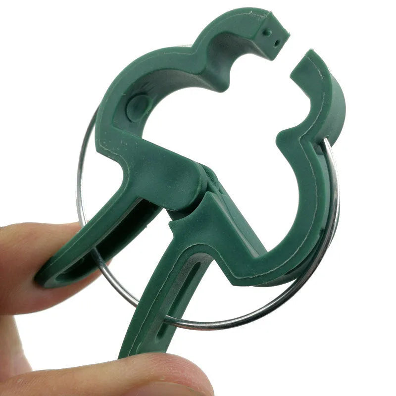 Green plastic and zinc plant fixing clips, large and small sizes, for training climbing vines and tomatoes.