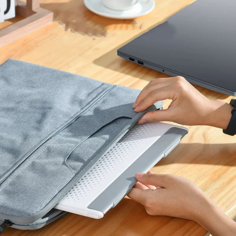 Dongdong portable alloy notebook stand in black shown on a desk