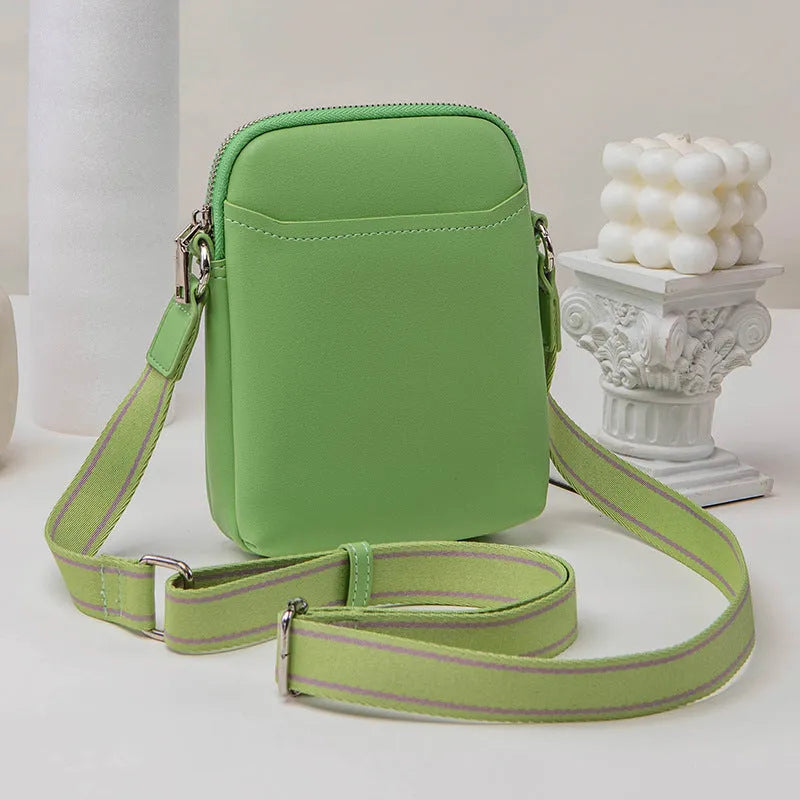 Solid colour small crossbody shoulder bag in PU leather measuring 14.5cm by 5.5cm by 19cm