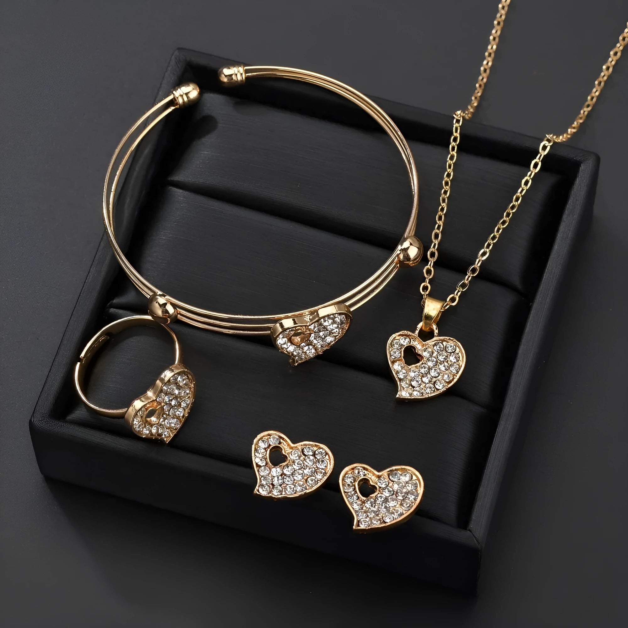 Gold-tone women's jewellery set with adjustable necklace, earrings, and hand decoration featuring love heart pendant