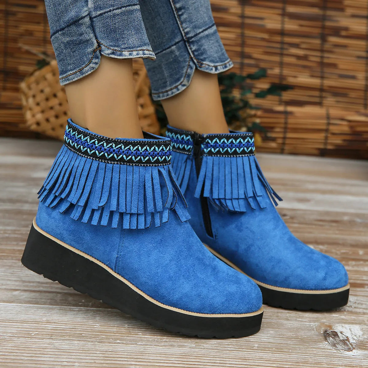 Women's dark brown suede wedge ankle boots with a side zipper and decorative tassel.