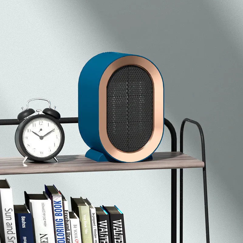 Compact black desktop electric fan heater with mechanical control dials and a safety grille.