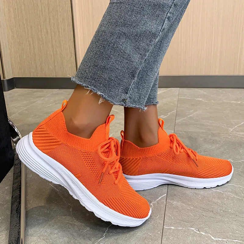 Women's mesh running shoes in Creamy White colour with Flyknit upper and rubber sole