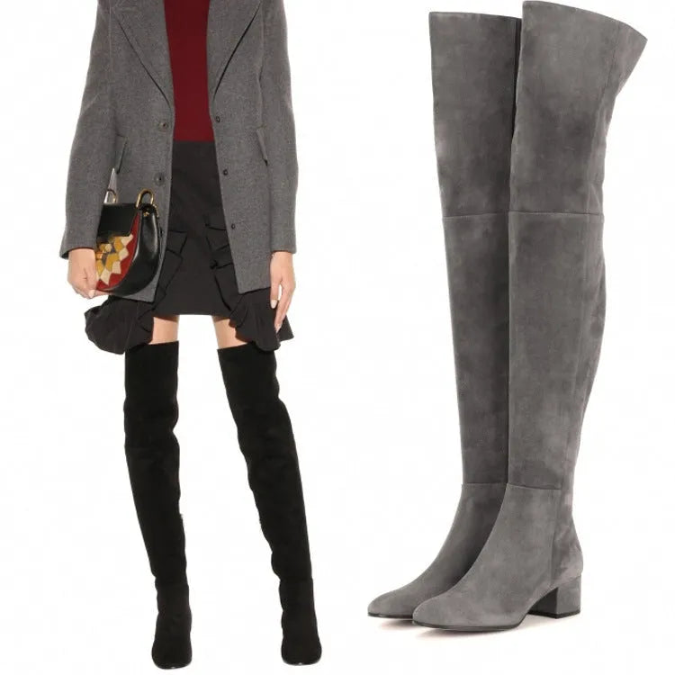 Grey women's flat over-the-knee suede boots with a pointed toe and low rubber heel.