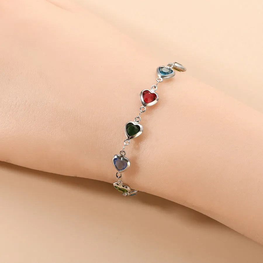 Devil's Eye geometric heart bracelet in stainless steel, shown in colourful, blue, green, and red finishes.