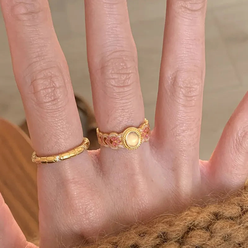 Geometric open ring for women with pink crystal enamel detail on a gold-plated copper band.