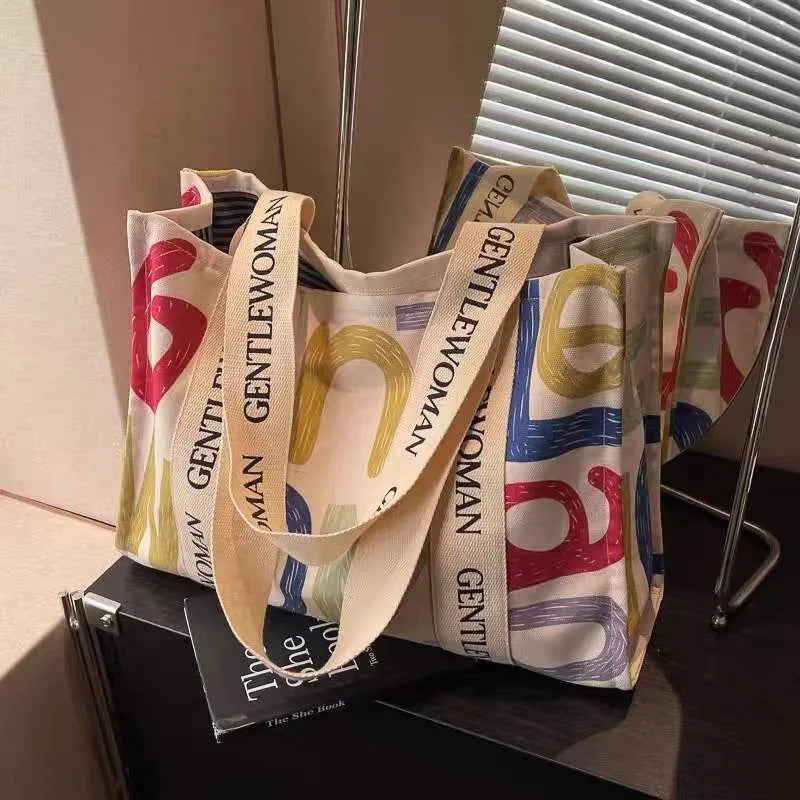 Large canvas women's tote bag with printed design, shown in available colour and pattern options