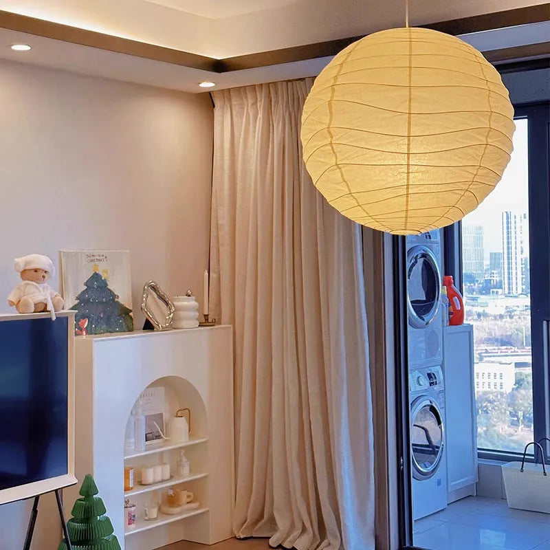 Japanese rice paper pendant chandelier with soft white shade in a living room setting.