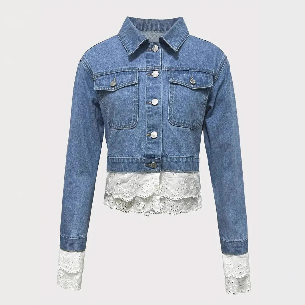 Blue denim jacket for women with lace stitching on the sleeves and front, shown on a hanger.