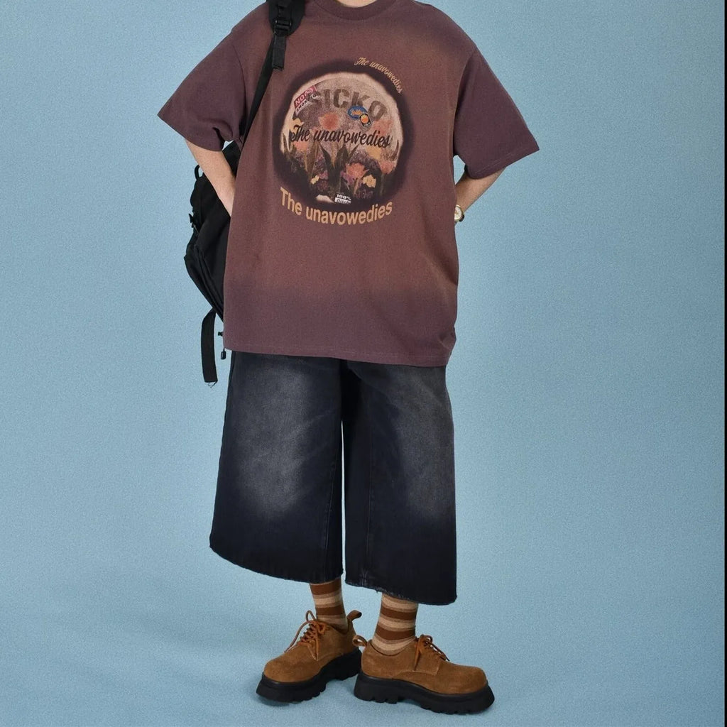 Men's loose straight-cut denim shorts in blue, shown on a hanger.