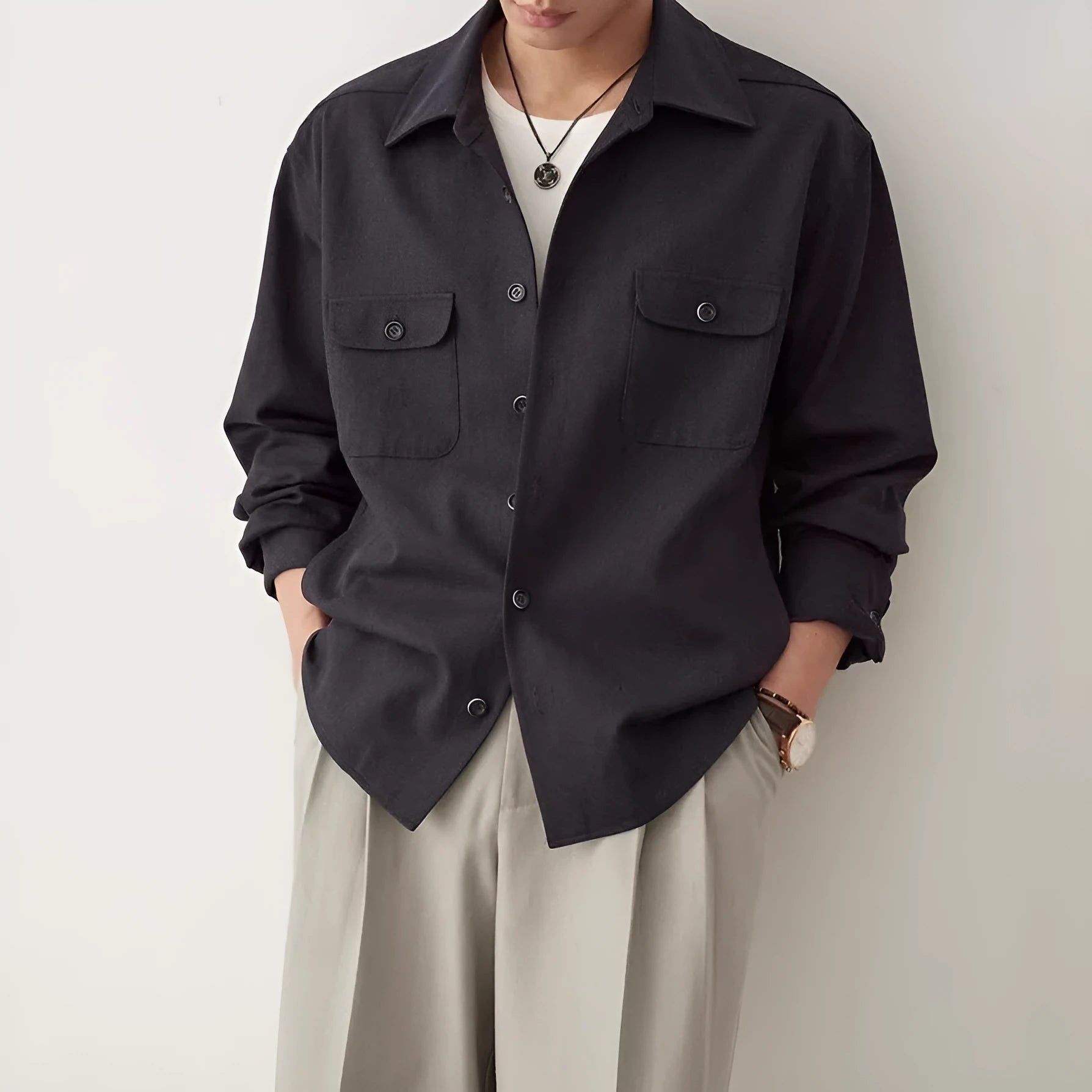 Men's light sand rice casual lapel collar long sleeve shirt on a hanger.
