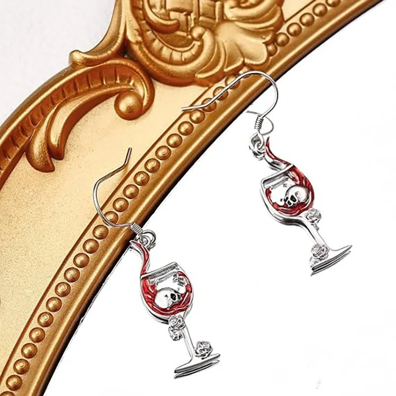A pair of zinc alloy skull wine glass earrings with an electroplated metallic finish.