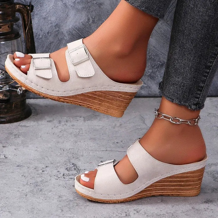 Women's creamy-white wedge beach slippers with buckle strap closure on rubber sole