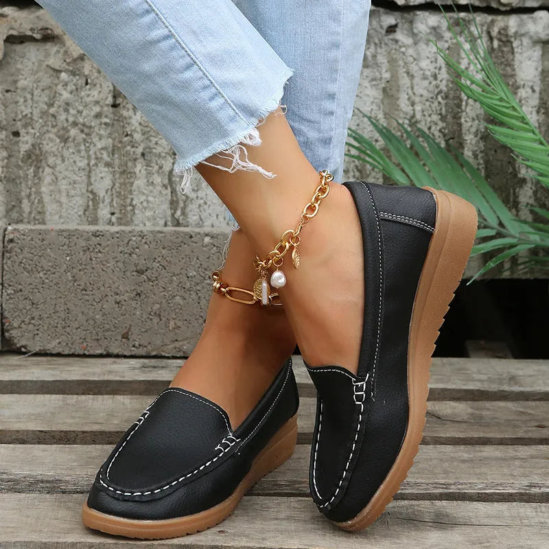 Women's flat loafer shoes in PU leather, showing round toe and car suture detail, on a rubber sole.