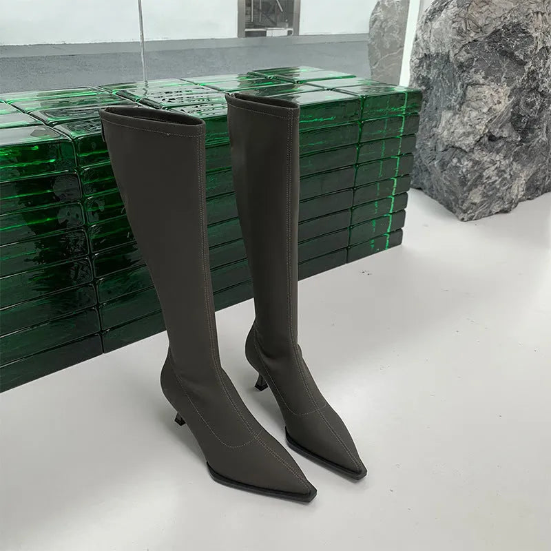 Black pointed toe below the knee stiletto heel boots with a back zipper fastening.