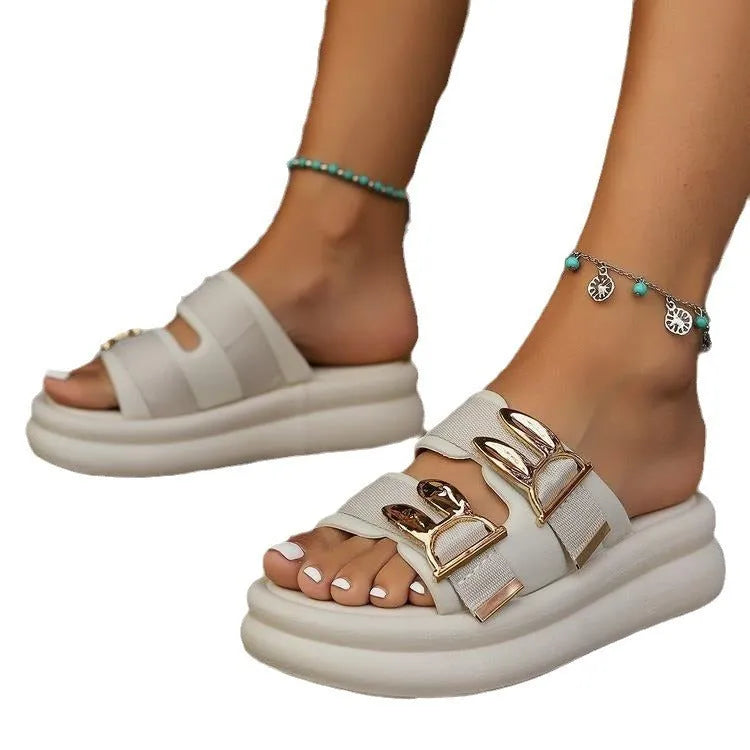 Women's apricot suede slippers with thick rubber sole on wooden floor