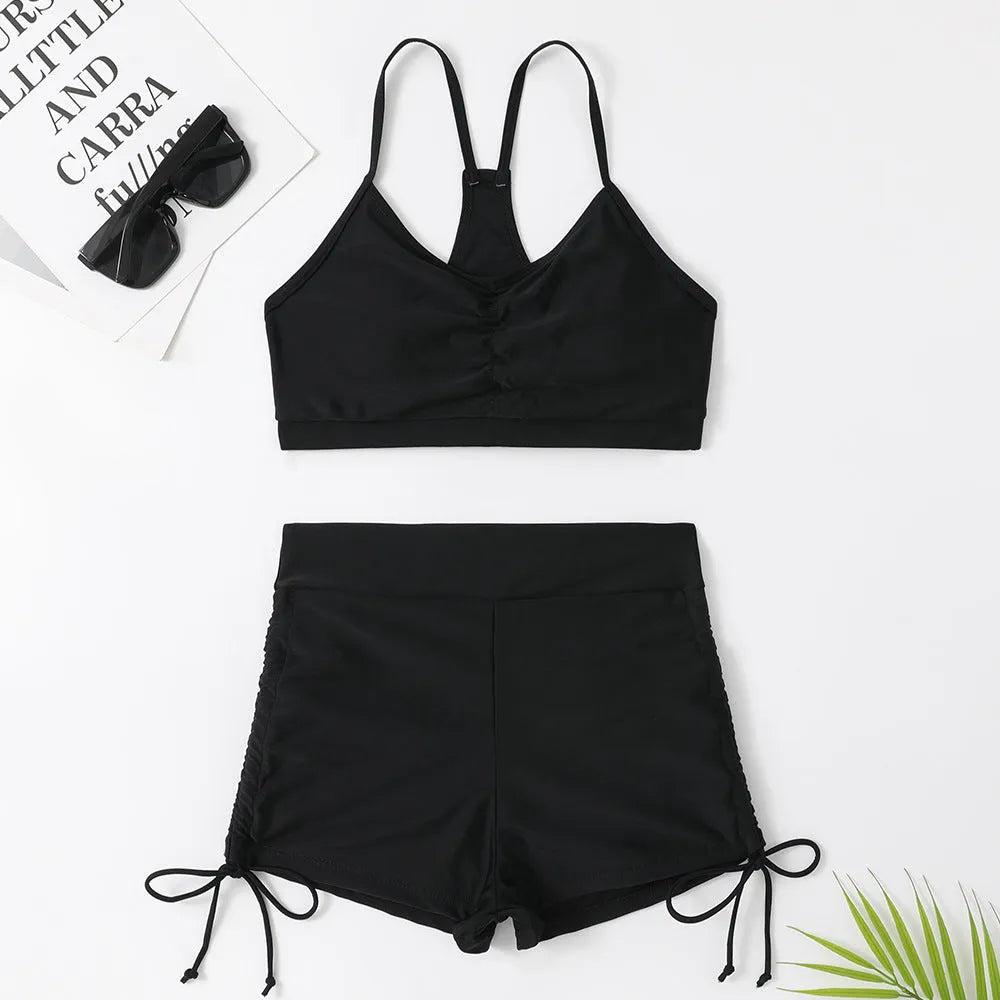 Women's high-waist split bikini swimsuit in black or purple colour with sleeveless design