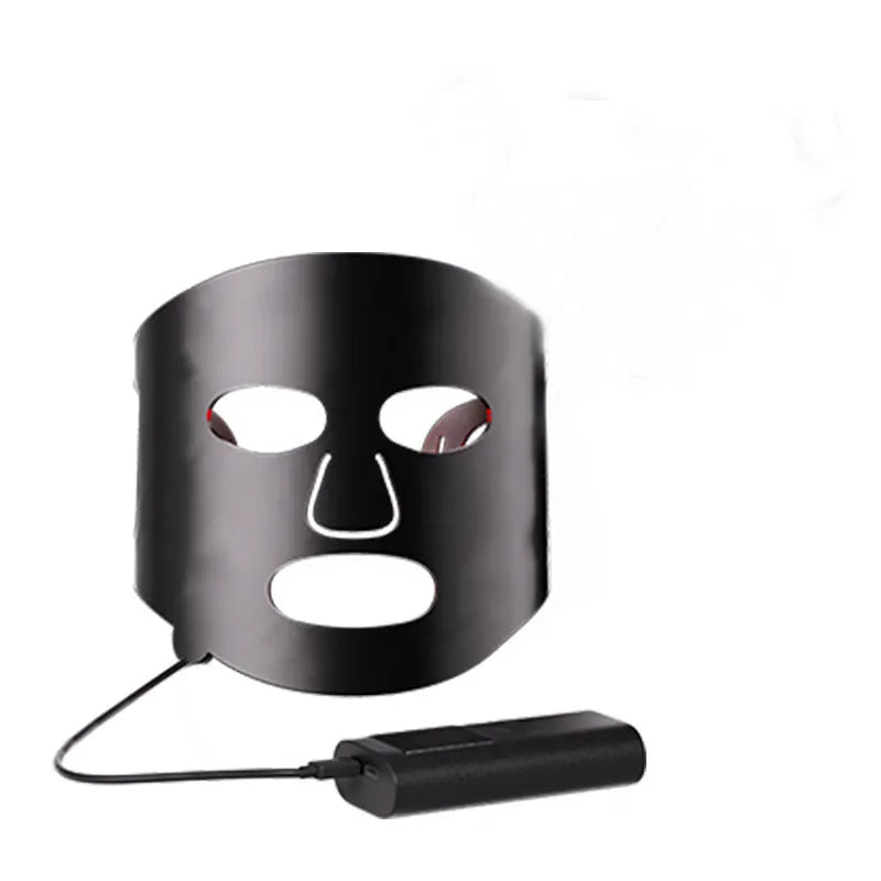 Black and gold LED phototherapy face mask with controller for home skin treatment.