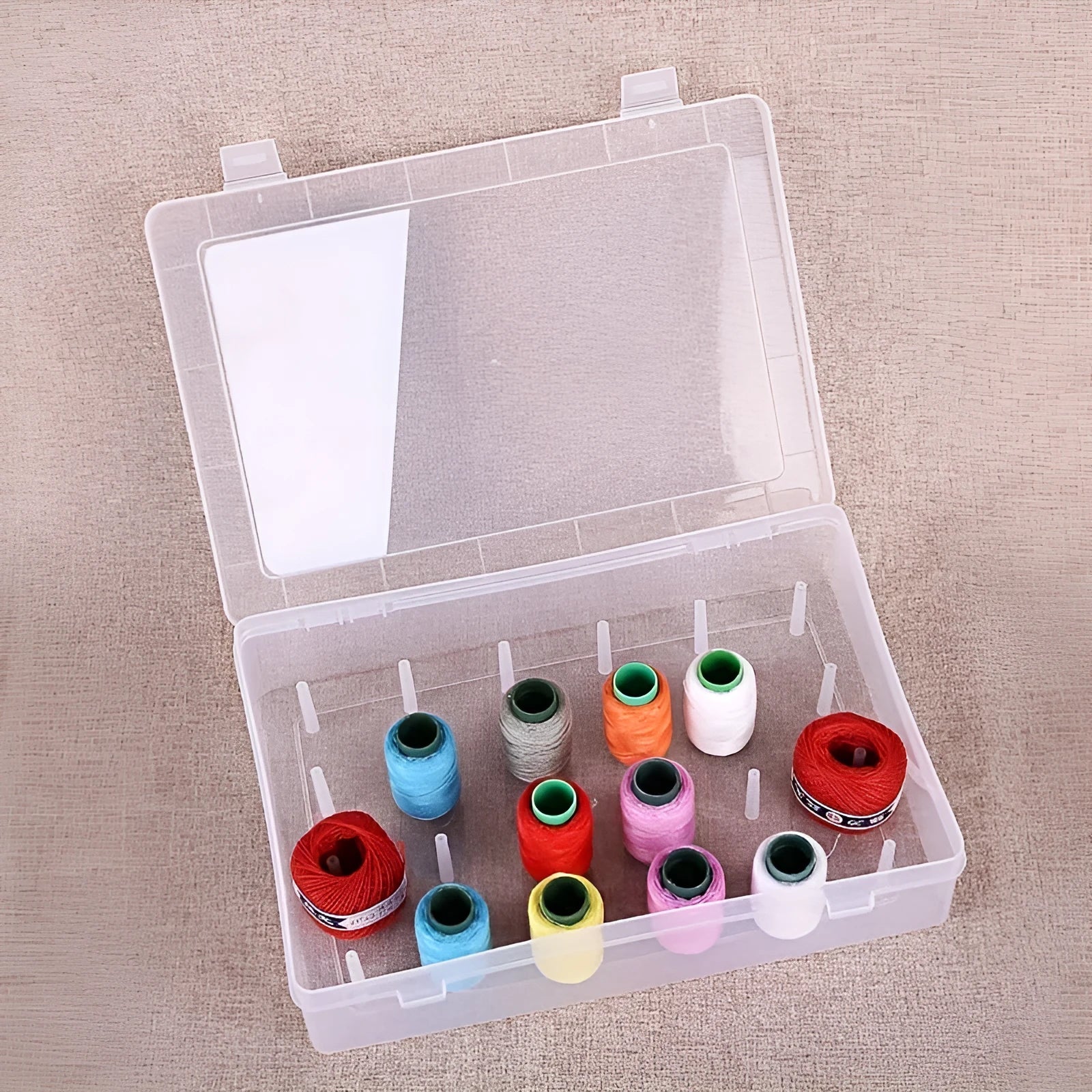 Plastic storage box with 42 compartments for organising embroidery needles and sewing supplies