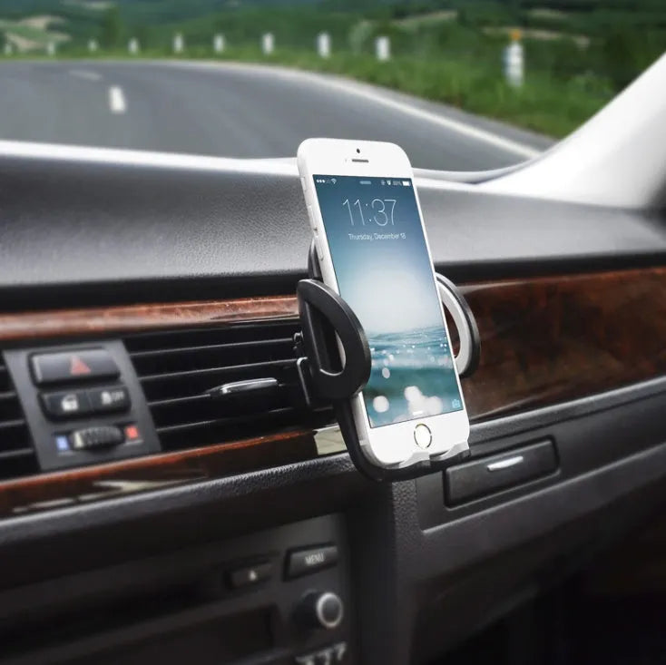 Black plastic car mobile phone holder mounted on vehicle air conditioning outlet