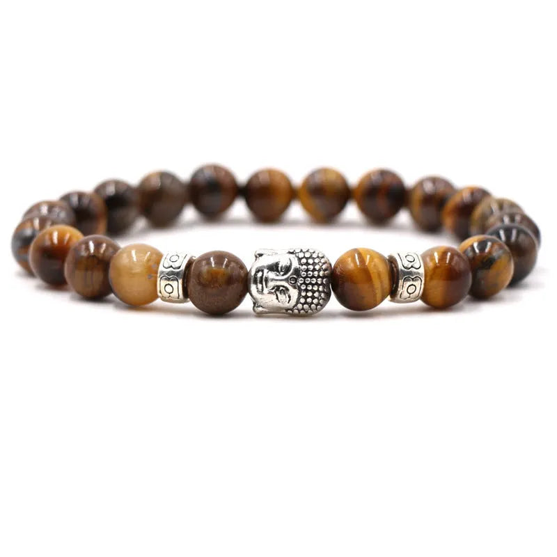 Tigereye stone Buddha head stretch bracelet with 8mm beads on a wrist.