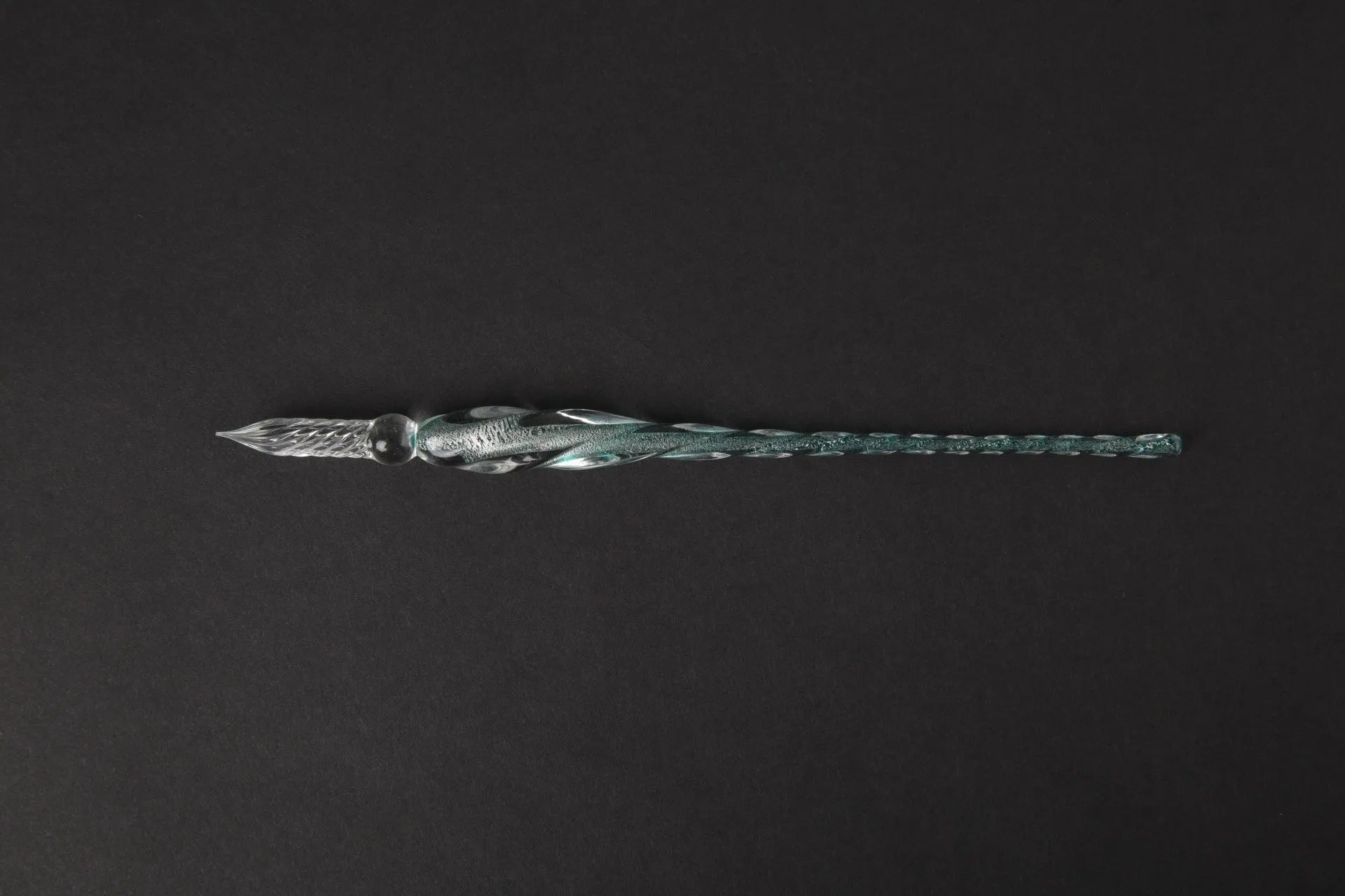 Transparent glass art pen with coloured ink dipped design in a gift box.