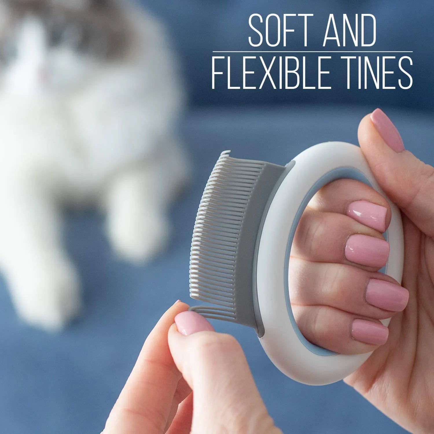 Blue pet deshedding comb with soft teeth and ergonomic plastic handle on a white background.
