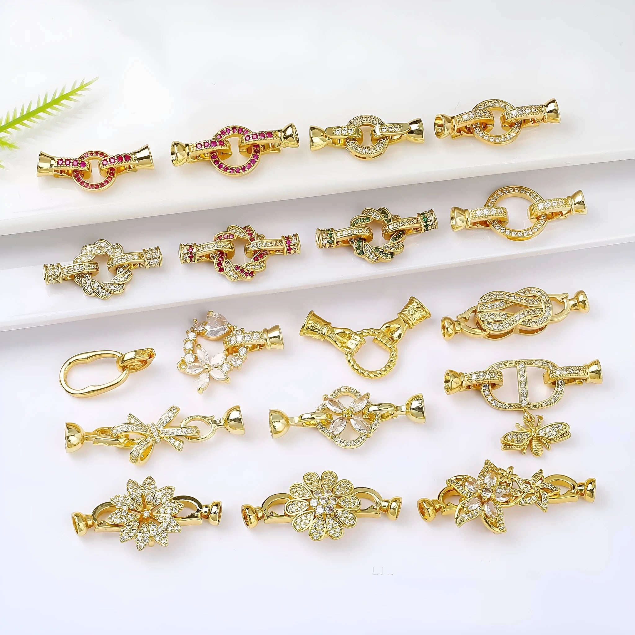 Small gold colour metal chain buckle for DIY necklace making on a white background.