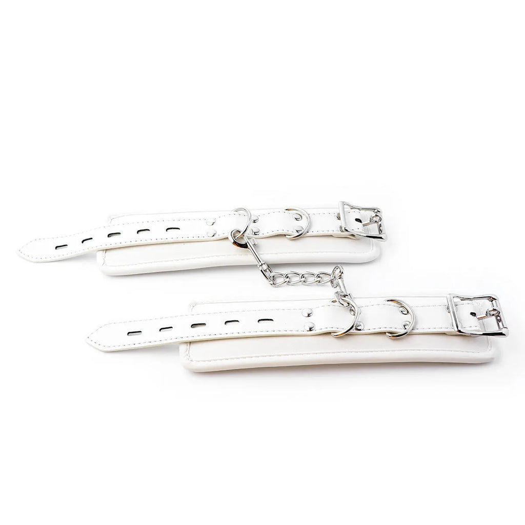 White PU sponge bondage restraint set showing handcuffs, footcuffs and neck cuff accessories