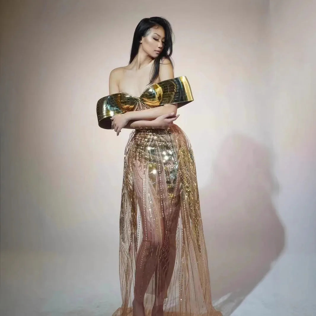 Gold sequined strapless dress with tulle skirt and thigh-high split, shown on mannequin