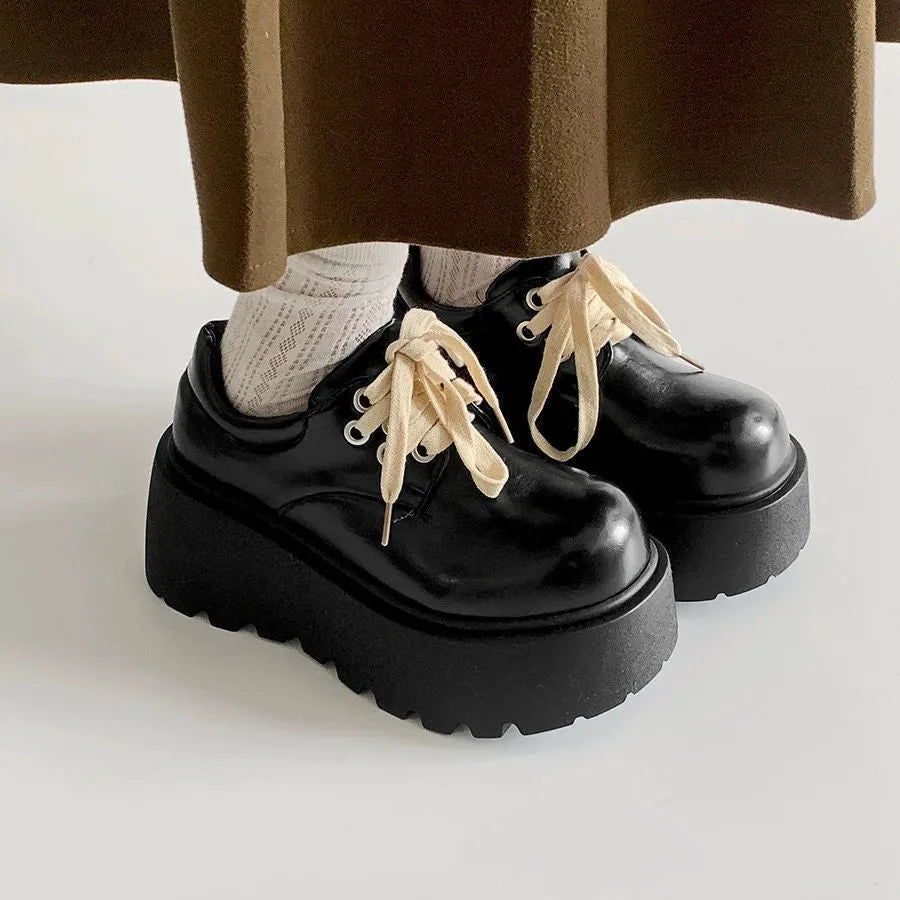 Women's matte black lace-up shoes with a chunky 6-8cm heel and thick rubber sole.
