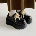 Women's matte black lace-up shoes with a chunky 6-8cm heel and thick rubber sole.