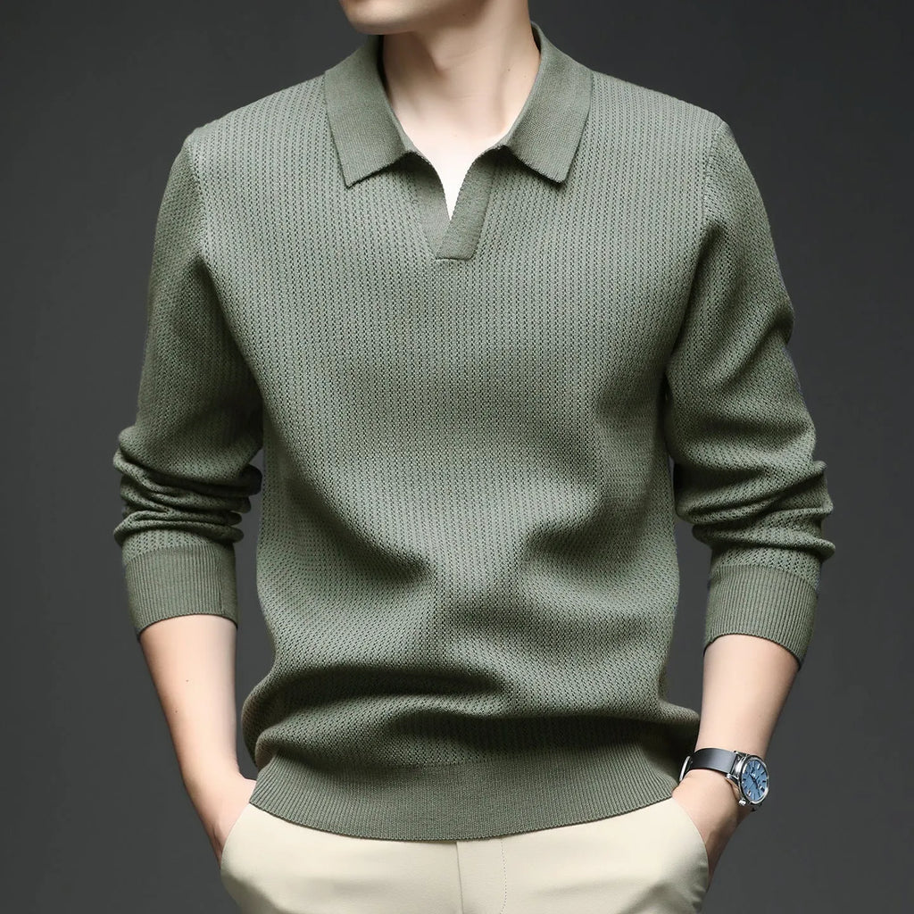 Men's loose green pullover sweater on a hanger, casual autumn wear.