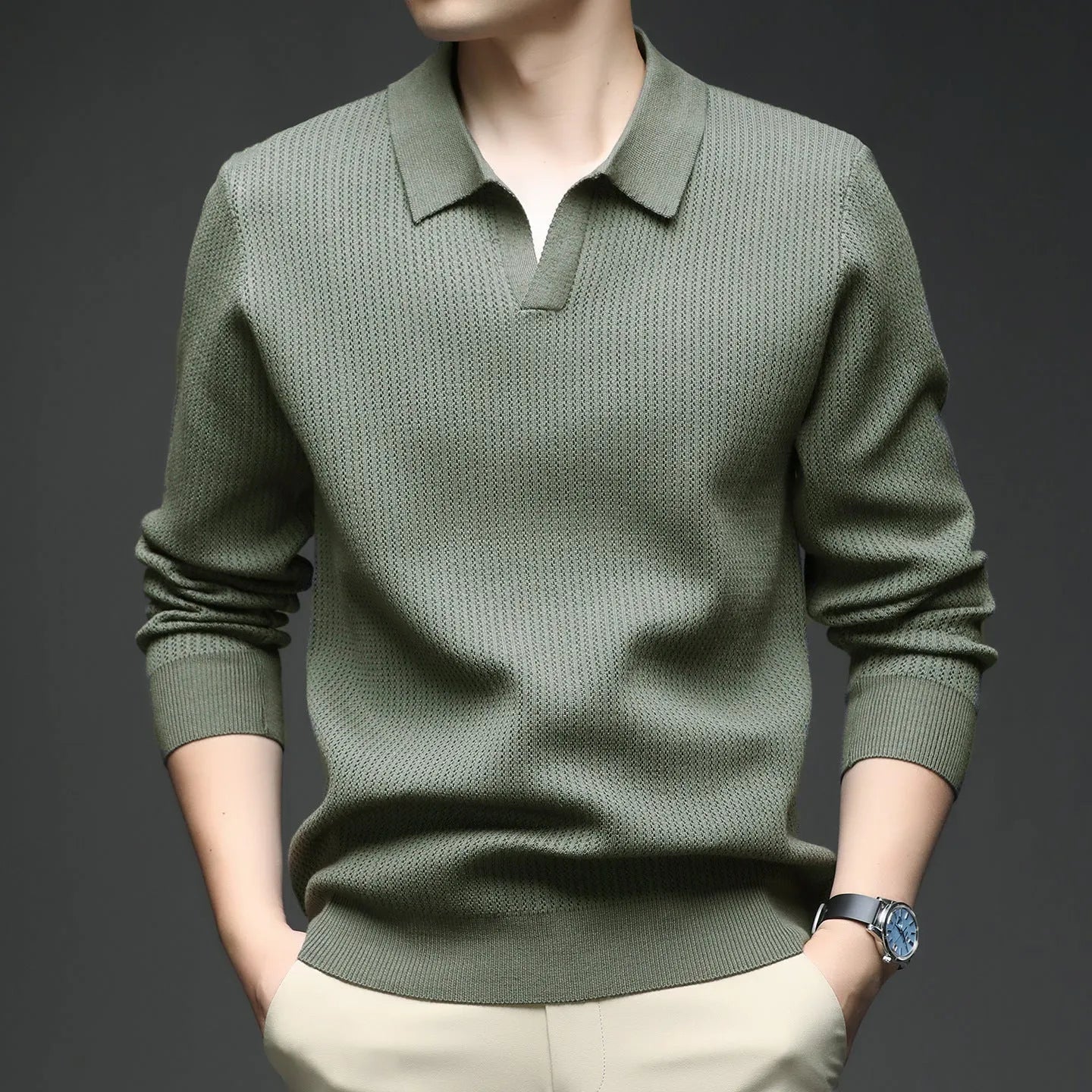 Men's loose green pullover sweater on a hanger, casual autumn wear.